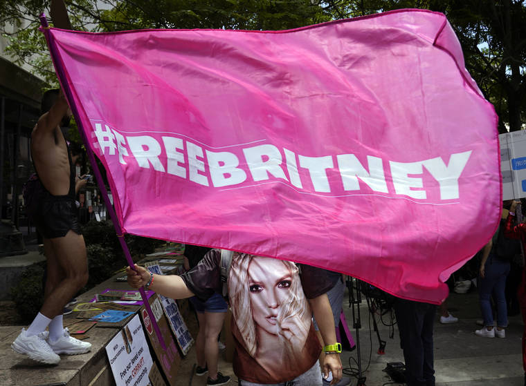 ASSOCIATED PRESS / JUNE 23
                                A Britney Spears supporter waves a “Free Britney” flag outside a court hearing concerning the pop singer’s conservatorship at the Stanley Mosk Courthouse in Los Angeles.
