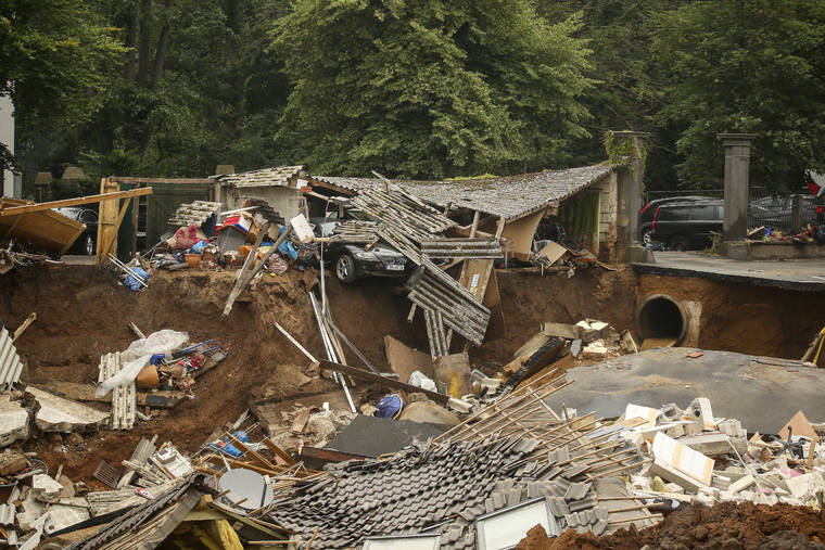 dpa VIA AP
                                Debris of collapsed houses is pictures in the Blessem district of Erftstadt, Germany.