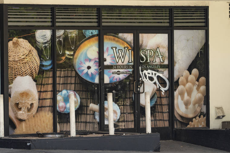ASSOCIATED PRESS / JULY 4
                                The exterior of a tagged window of the Wi Spa in Koreatown district in Los Angeles. Police declared an unlawful assembly and fired non-lethal projectiles to disperse an unruly crowd on Saturday, July 17, after a dueling protest over transgender rights at the Los Angeles spa turned violent. The protests stemmed from a video that circulated online earlier this month, in which an irate customer complained to the staff at Wi Spa that a transgender woman was in the women’s section of the spa.
