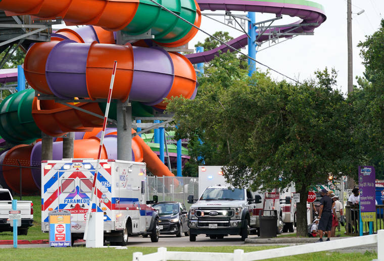 MELISSA PHILLIP/HOUSTON CHRONICLE VIA AP
                                Emergency personnel vehicles are parked near the scene where people are being treated after chemical leak at Six Flags Hurricane Harbor Splashtown in Spring, Texas