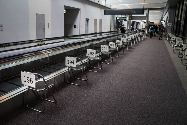 ASSOCIATED PRESS
                                Chairs are numbered in the holding area for foreign visitors at the Narita International Airport.