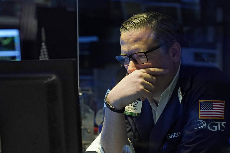 ASSOCIATED PRESS
                                Specialist Gregg Maloney worked on the floor of the New York Stock Exchange, today. Resurgent pandemic worries knocked stocks lower from Wall Street to Tokyo today, fueled by fears that a faster-spreading variant of the virus may upend the economy’s strong recovery.