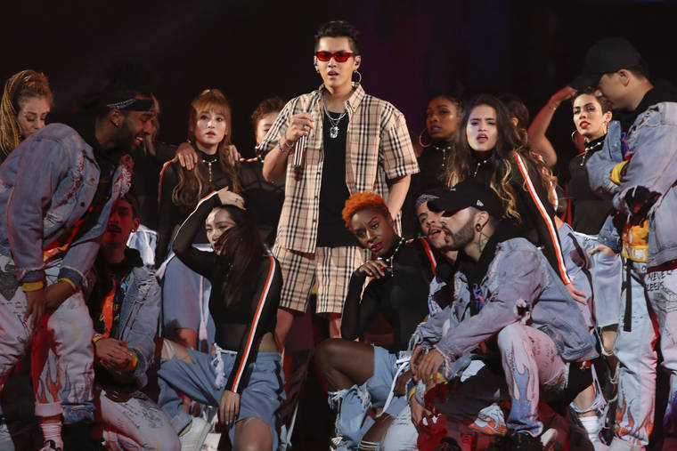 CHINATOPIX VIA ASSOCIATED PRESS
                                Singer Kris Wu, center, performed in the 2017 Tmall 11.11 Global Shopping Festival gala, in Shanghai, China in November 2017. The popular Chinese-Canadian singer, Kris Wu, has lost endorsement deals with at least 10 brands including Porsche and Louis Vuitton after a teenager accused him of having sex with her while she was drunk.