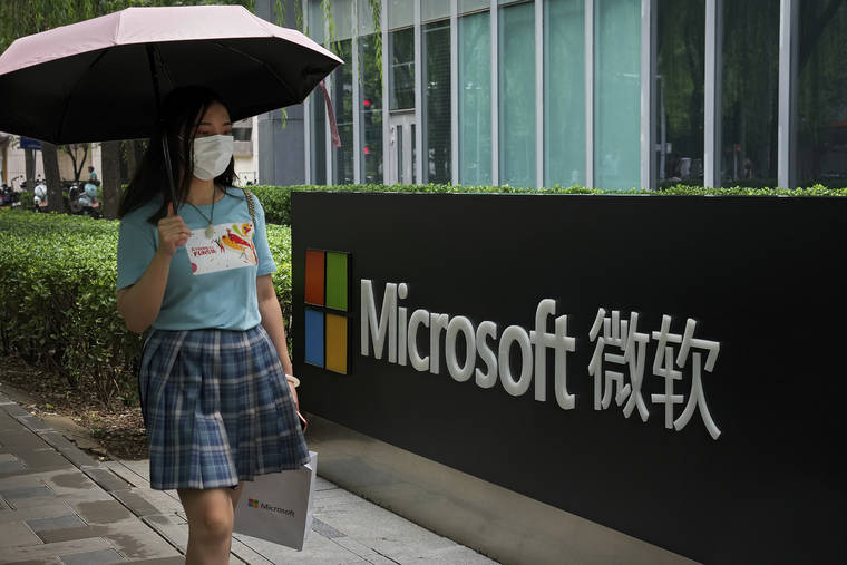 ASSOCIATED PRESS
                                A woman wearing a face mask to help curb the spread of the coronavirus walked by the Microsoft office building in Beijing, Tuesday. China on Tuesday rejected an accusation by Washington and its Western allies that Beijing is to blame for a hack of the Microsoft Exchange email system and complained Chinese entities are victims of damaging U.S. cyberattacks.