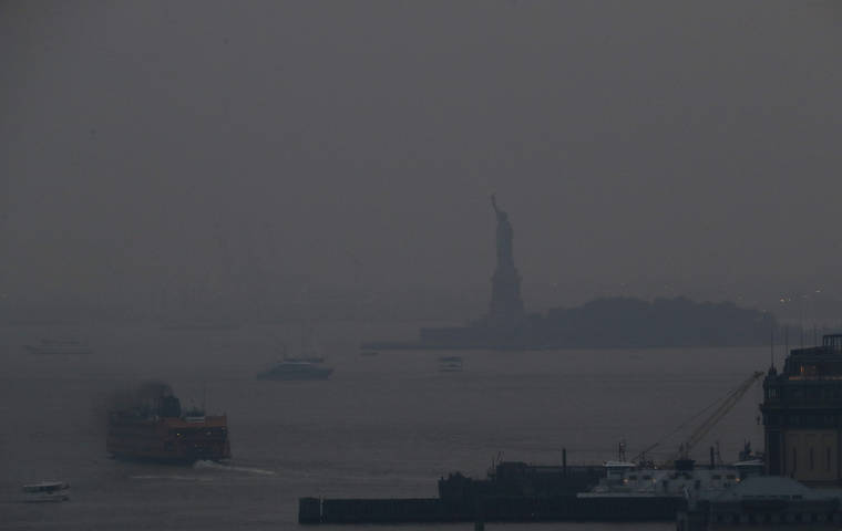 ASSOCIATED PRESS
                                The Staten Island Ferry departed from the Manhattan terminal through a haze of smoke with the Statue of Liberty barely visible, Tuesday, in New York. Wildfires in the American West, including one burning in Oregon that’s currently the largest in the U.S., are creating hazy skies as far away as New York as the massive infernos spew smoke and ash into the air in columns up to six miles high.