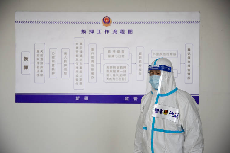 ASSOCIATED PRESS
                                A security officer in a protective suit stands in front of a chart at the visitors’ hall at the Urumqi No. 3 Detention Center in Dabancheng in western China’s Xinjiang Uyghur Autonomous Region.