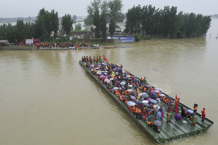 CHINATOPIX VIA ASSOCIATED PRESS
                                Rescuers used a motorized raft bridge to evacuate residents from a flooded rural area in Xinxiang in central China’s Henan Province, Friday. The death toll from catastrophic flooding in the central Chinese city of Zhengzhou has continued to rise, state media reported Friday.