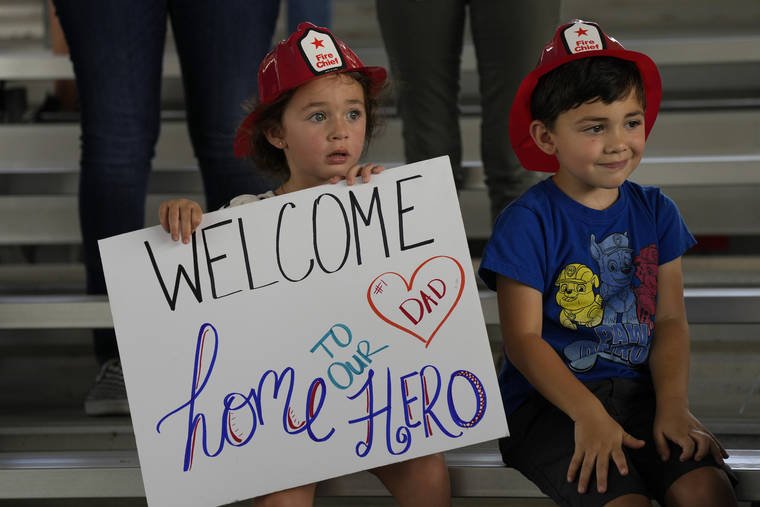 ASSOCIATED PRESS
                                Isabella, 3, and Eric, 4, wait to welcome home their father, Capt. Eric Hernandez, as members of Miami-Dade Fire Rescue’s urban search and rescue team are reunited with their families after weeks of working on the rubble pile at the collapsed Champlain Towers South condominium, on Friday, July 23, in Doral, Fla.
                                ASSOCIATED PRESS
                                Isabella, 3, and Eric, 4, wait to welcome home their father, Capt. Eric Hernandez, as members of Miami-Dade Fire Rescue’s urban search and rescue team are reunited with their families after weeks of working on the rubble pile at the collapsed Champlain Towers South condominium, on Friday, July 23, in Doral, Fla.
