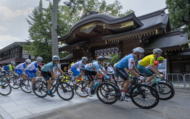 THE CANADIAN PRESS VIA AP
                                Canada’s Michael Woods, foreground right, and other riders round a corner in front of the Okunitama Shrine during the men’s cycling road race.
