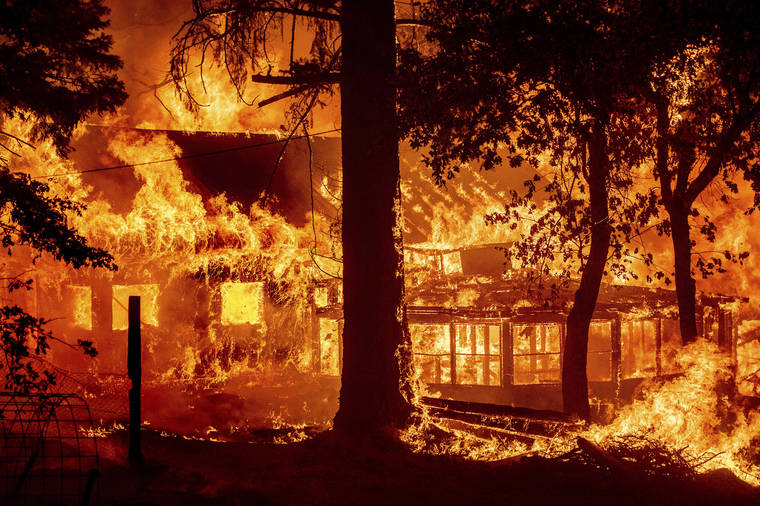ASSOCIATED PRESS
                                Flames from the Dixie Fire consume a home in the Indian Falls community of Plumas County, Calif., on Saturday. The fire destroyed multiple residences as it tore through the area.