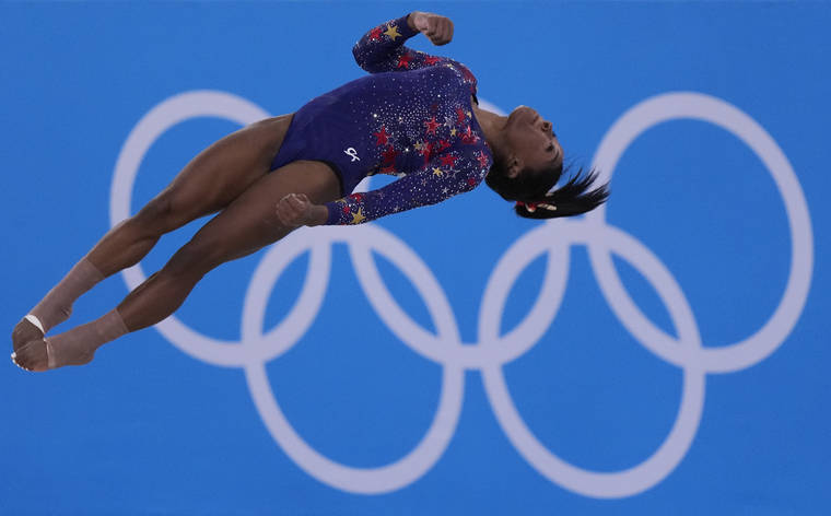 ASSOCIATED PRESS
                                Simone Biles performs her floor exercise routine during the women’s artistic gymnastic qualifications at the 2020 Summer Olympics on Sunday.