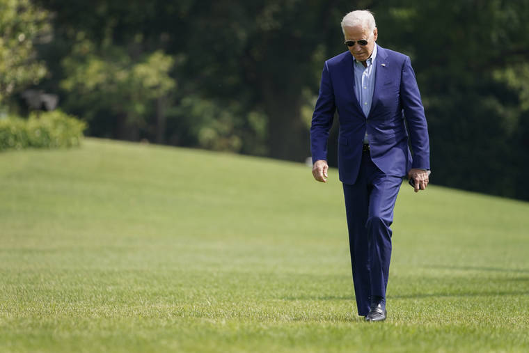 ASSOCIATED PRESS
                                President Joe Biden walks on the South Lawn of the White House after stepping off Marine One Sunday in Washington.