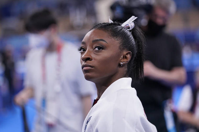 ASSOCIATED PRESS
                                Simone Biles waits for her turn to perform during the artistic gymnastics women’s final at the Summer Olympics today in Tokyo.