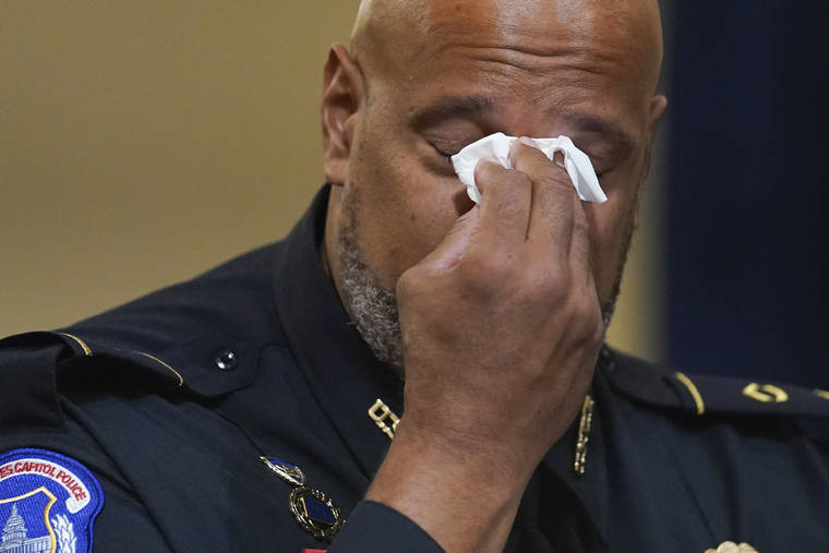 ASSOCIATED PRESS
                                Washington Metropolitan Police Department officer Daniel Hodges wipes his eyes during the House select committee hearing on the Jan. 6 attack on Capitol Hill in Washington Tuesday.