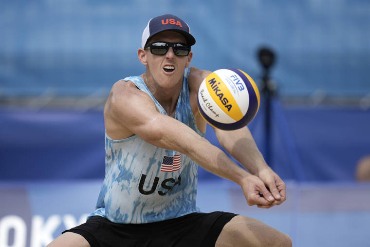 ASSOCIATED PRESS
                                Tri Bourne, of the United States, returns a shot during a men’s beach volleyball match against Switzerland at the 2020 Summer Olympics, Wednesday, in Tokyo, Japan.