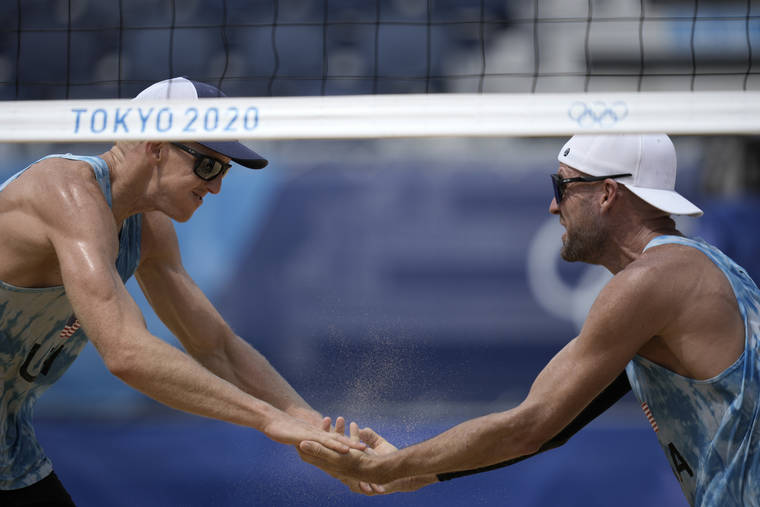 ASSOCIATED PRESS
                                Tri Bourne, left, of the United States, celebrates with teammate Jacob Gibb, after winning a men’s beach volleyball match against Switzerland on Wednesday.