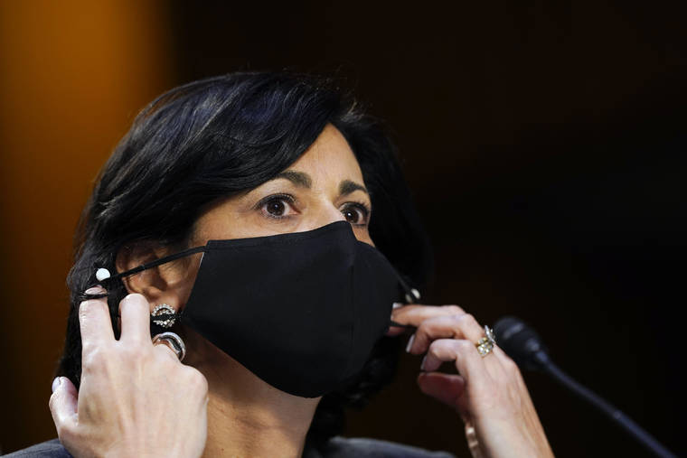 ASSOCIATED PRESS / MARCH 18
                                Dr. Rochelle Walensky, director of the Centers for Disease Control and Prevention, says new mask-wearing guidance, coupled with higher rates of vaccination against COVID-19, could halt the current escalation of infections in “a couple of weeks.” Walensky is seen here adjusting her face mask during a Senate committee hearing on the federal coronavirus response on Capitol Hill in March.