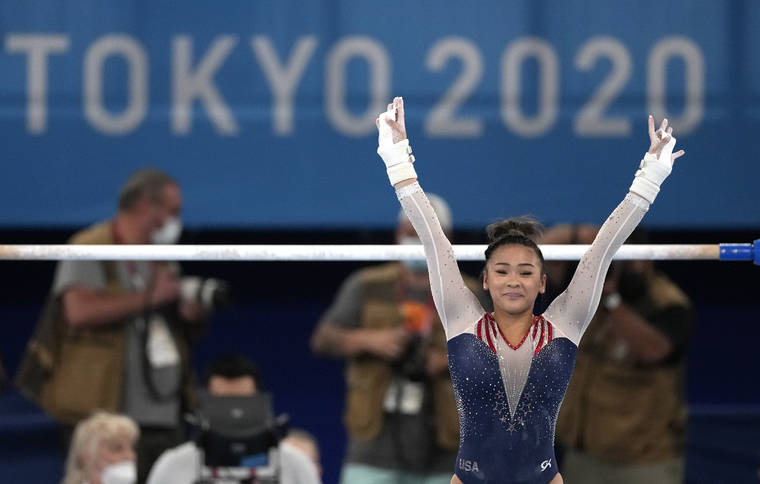 ASSOCIATED PRESS
                                Sunisa Lee finishes on the uneven bars during the artistic gymnastics women’s all-around final at the 2020 Summer Olympics today in Tokyo.