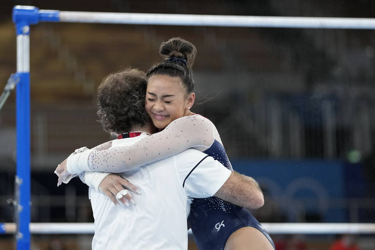 ASSOCIATED PRESS
                                Sunisa Lee embraces her coach Jeff Graba after performing on the uneven bars during the artistic gymnastics women’s all-around final at the 2020 Summer Olympics today in Tokyo.