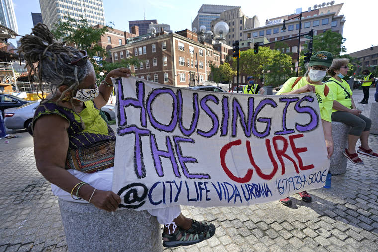 ASSOCIATED PRESS / JUNE 9
                                Demonstrators hold a sign during a rally in Boston protesting housing eviction in June. The Biden administration today said it will allow a nationwide ban on evictions to expire Saturday.