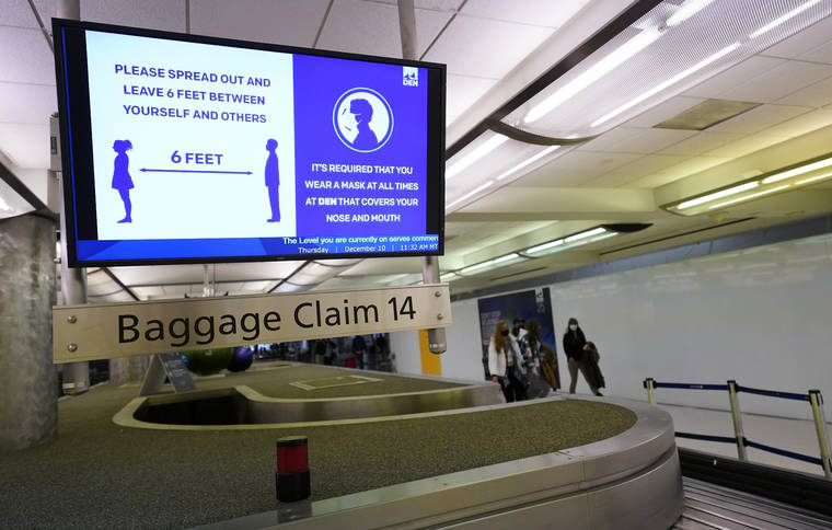 ASSOCIATED PRESS / 2020
                                An electronic sign warns travelers to maintain social distance in the terminal of Denver International Airport in Denver.