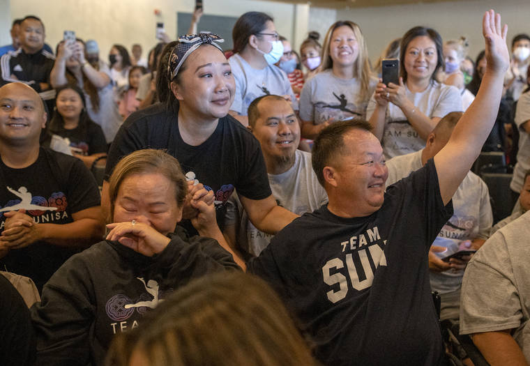 STAR TRIBUNE VIA AP
                                Sunisa Lee’s parents Yeev Thoj, left, and John Lee and other family and friends react as they watch Sunisa Lee clinch the gold medal.