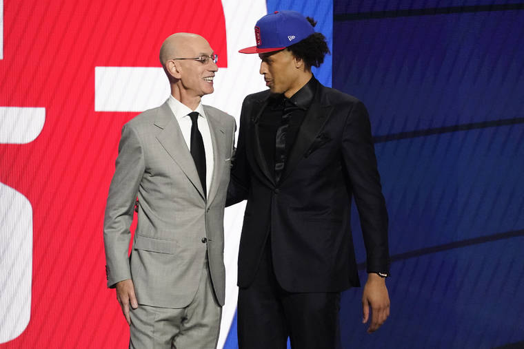 ASSOCIATED PRESS
                                NBA Commissioner Adam Silver greets Cade Cunningham who was picked as the number one overall pick by the Detroit Pistons.