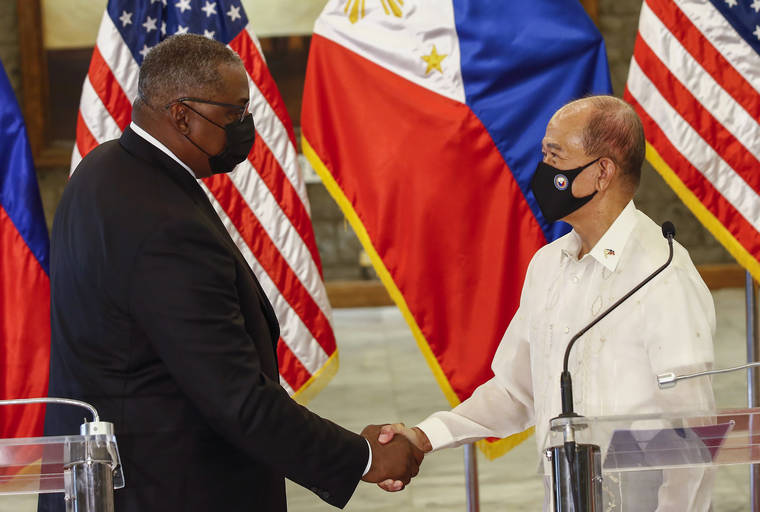 ASSOCIATED PRESS
                                United States Defense Secretary Lloyd Austin, left, and Philippines Defense Secretary Delfin Lorenzana shake hands after a bilateral meeting at Camp Aguinaldo military camp in Quezon City, Metro Manila, Philippines. Austin is visiting Manila to hold talks with Philippine officials to boost defense ties and possibly discuss the The Visiting Forces Agreement between the US and Philippines.
