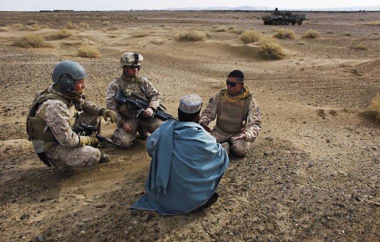 ASSOCIATED PRESS
                                United States Marine Sgt. Isaac Tate, left, and Cpl. Aleksander Aleksandrov, center, interview a local Afghan man with the help of a translator from the 2nd MEB, 4th Light Armored Reconnaissance Battalion on a patrol in the volatile Helmand province of southern Afghanistan in 2009.