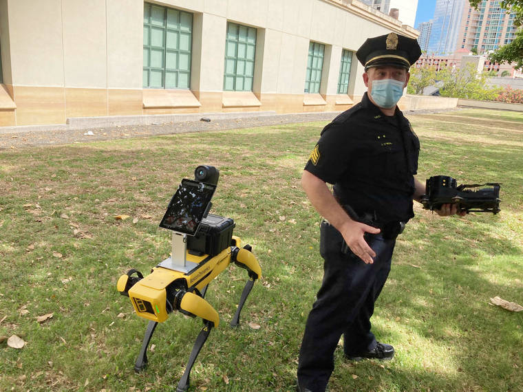 ASSOCIATED PRESS / MAY 14
                                Honolulu Police Acting Lt. Joseph O’Neal demonstrates a robotic dog in Honolulu.