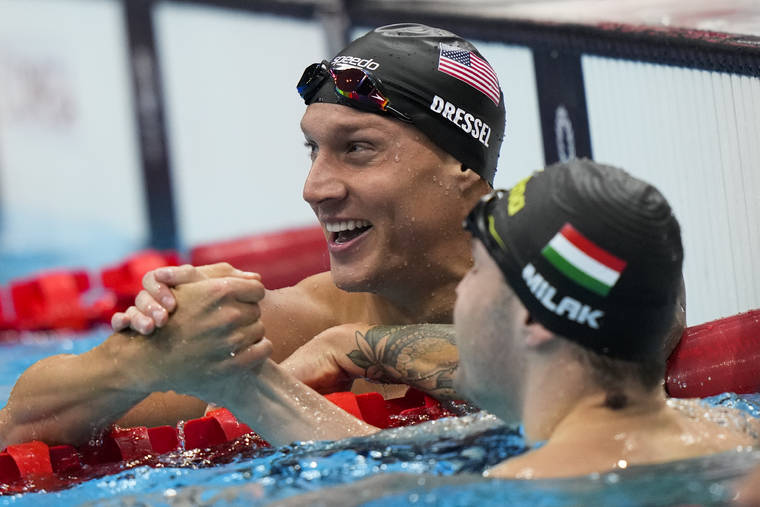 ASSOCIATED PRESS
                                Caeleb Dressel, of United States, celebrates after wining the gold medal in the men’s 100-meter butterfly final at the 2020 Summer Olympics, Saturday, in Tokyo, Japan.