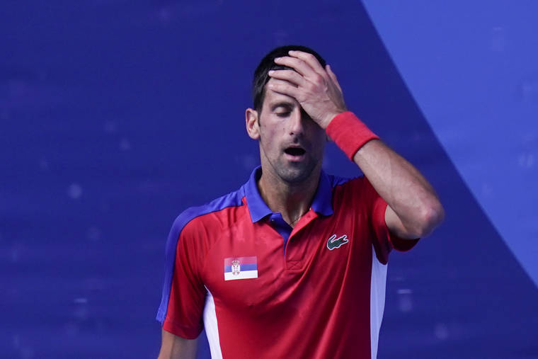 ASSOCIATED PRESS
                                Novak Djokovic, of Serbia, reacts during the bronze-medal match of the tennis competition against Pablo Carreno Busta.