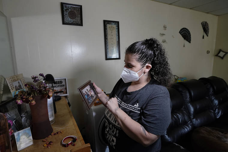 ASSOCIATED PRESS
                                Roxanne Schaefer holds a photograph in the living room of her apartment, in West Warwick, R.I., Tuesday. Schaefer, who is months behind on rent, is bracing for the end to a federal moratorium today, a move that could result in millions of people being evicted just as the highly contagious delta variant of the coronavirus is rapidly spreading.