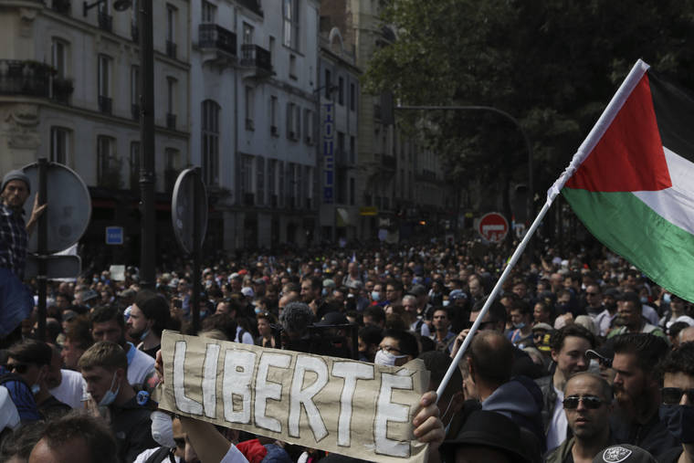 ASSOCIATED PRESS
                                Protesters hold up a banner which reads ‘freedom’ in French during a demonstration in Paris today. Demonstrators gathered in several cities in France to protest against the COVID-19 pass, which grants vaccinated individuals greater ease of access to venues.