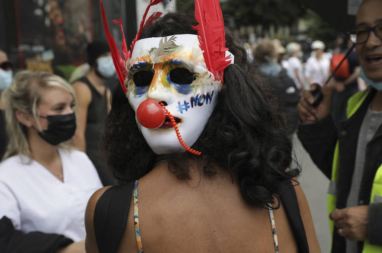 ASSOCIATED PRESS
                                A protester wears a mask on the back of her head which says “no” in French as she attends a demonstration in Paris, France, today. Demonstrators gathered in several cities in France to protest against the COVID-19 pass, which grants vaccinated individuals greater ease of access to venues.
