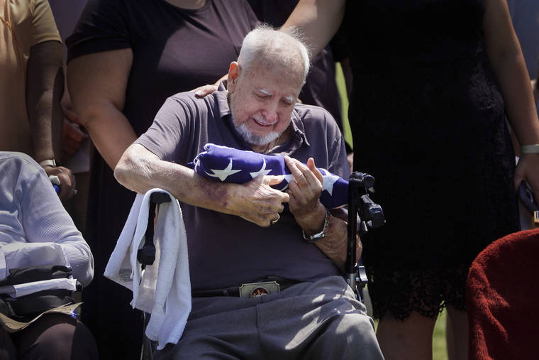 LAUREN SCHNEIDERMAN / PHILADELPHIA INQUIRER VIA AP
                                Walter Wilkins, 86, tears up while holding an American flag presented to him by the Army at his brother Cpl. Paul Wilkins’ funeral on, June 26 in Bellwood, Pa. The Army declared Cpl. Wilkins missing in action in July 1950 during the Korean War, and his remains were finally identified 70 years later. Walter was a teenager the last time he saw his brother.