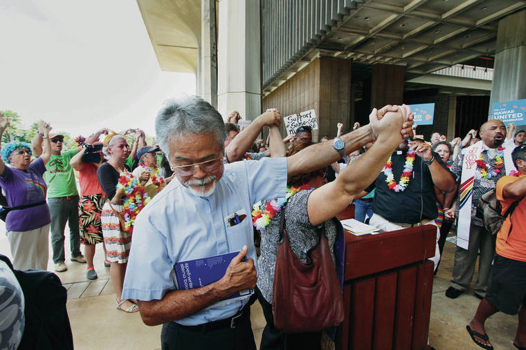 STAR-ADVERTISER / 2013
                                The Rev. Bob Nakata joined hands during a gathering at the state Capitol supporting a gay marriage bill in 2013.