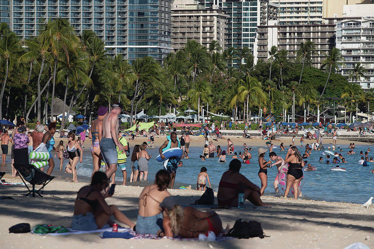 CINDY ELLEN RUSSELL / CRUSSELL@STARADVERTISER.COM
                                Beachgoers gathered along the shore and waters of Waikiki last month.