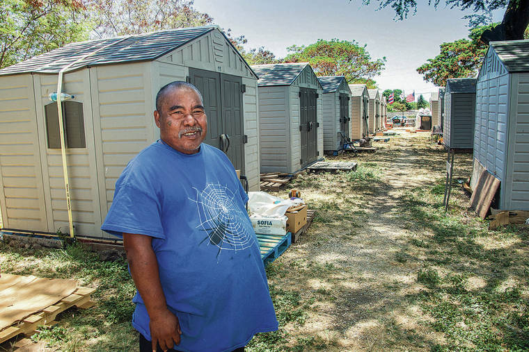 CRAIG T. KOJIMA / CKOJIMA@STARADVERTISER.COM
                                Wai Anson has been living at HI Good Samaritan Foundation’s shelter in Waianae since November. The foundation, which was started by Cedar Church, put up 50 plastic sheds to house the homeless but did the work without a building permit.
