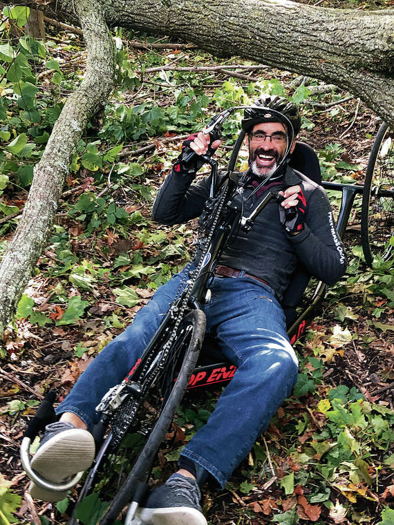 NEIL STANTON VIA THE NEW YORK TIMES
                                Todd Balf pedals beneath a storm-tossed tree on a cycling route. Using a hand-powered recumbent trike after spine cancer, Stanton retraced the 35 miles of a pioneering cycling tour of Boston’s North Shore taken more than a century ago.