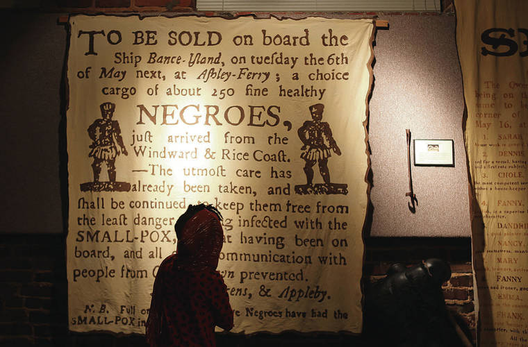 TRIBUNE NEWS SERVICE 
                                Tours to sites associated with the civil rights movement in Atlanta have slowly seen a resurgence in the last few weeks. A teen looks over a slave notice at the APEX Museum in Atlanta.