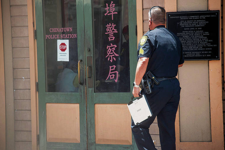CRAIG T. KOJIMA / CKOJIMA@STARADVERTISER.COM
                                An officer walked into the Chinatown Police Station on July 13.