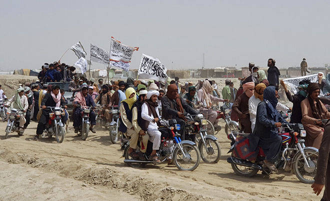 ASSOCIATED PRESS / JULY 14
                                Supporters of the Taliban carry their signature white flags after the Taliban said they seized the Afghan border town of Spin Boldaka across from the town of Chaman, Pakistan, this month.