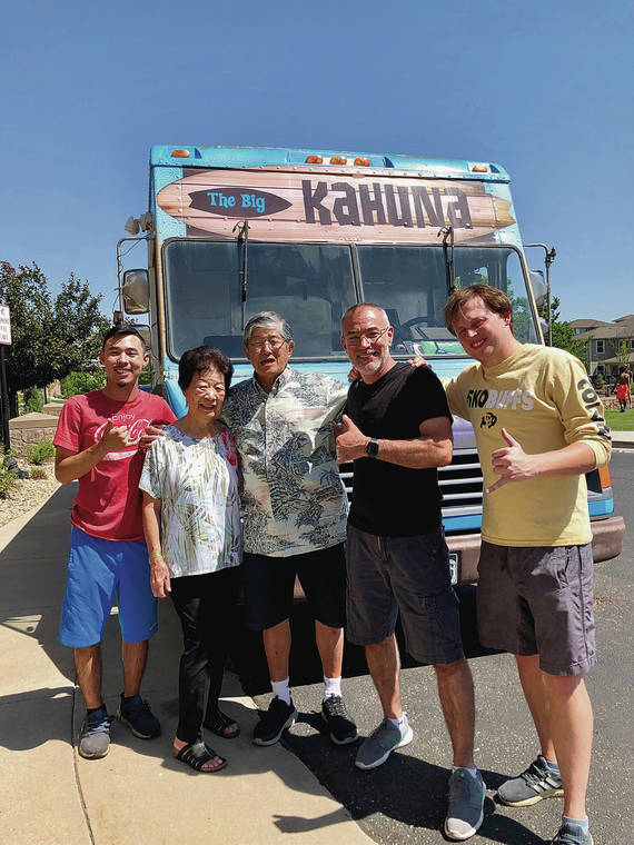 In June, Honolulu residents Gladys and Gerald Ching, second and third from left, discovered the Ohana Grille food truck in Denver. Owner/chef Rich Braunthal, fourth from left, posed with the couple, Braunthal’s son, Jacob, far left, and an employee. Photo by Loretta Nekota.