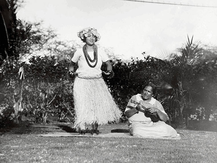 COURTESY THE JOHN AND KATE KELLY ESTATE
                                Kate Kelly took hundreds of photos documenting life in a fishing village near her Black Point home. Here, her close friend Kilikina Makaloa plays ukulele for a dancer.