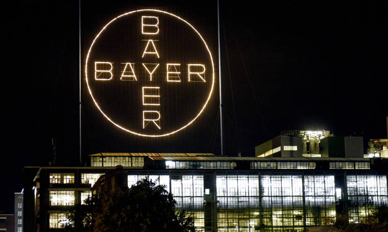 ASSOCIATED PRESS / 2019
                                The Bayer logo shines at night at the main chemical plant of German Bayer AG in Leverkusen, Germany.