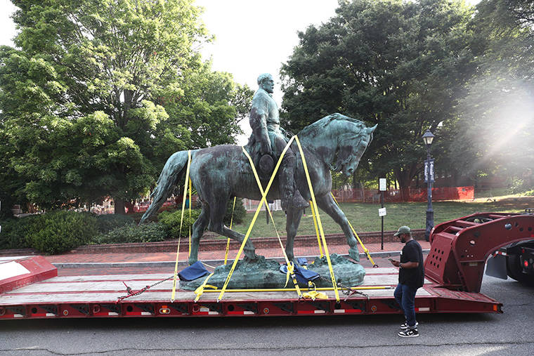 ERIN EDGERTON/THE DAILY PROGRESS VIA AP
                                The monument of Robert E. Lee is removed on Saturday, July 10, 2021 in Charlottesville, Va. The removal of the Lee and Jackson statues comes nearly four years after violence erupted at the infamous “Unite the Right” rally.