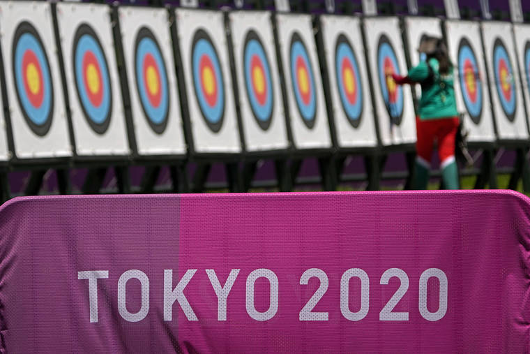 ASSOCIATED PRESS
                                An athlete collects her arrows as she practices for the 2020 Summer Olympics at Yumenoshima Park Archery Field on Sunday.