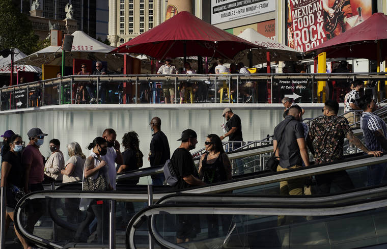 ASSOCIATED PRESS / APRIL 24
                                People walk as others dine on the Las Vegas Strip, in Las Vegas.