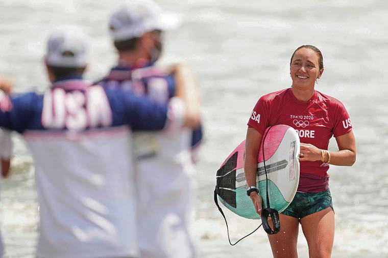 ASSOCIATED PRESS
                                Carissa Moore, smiles after wining her heat during third round of women’s surfing competition at the 2020 Summer Olympics at Tsurigasaki beach in Ichinomiya Monday in Japan.